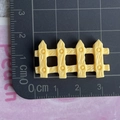 Macro view of a 3.5cm yellow resin fence miniature with wood texture on a ruler - Yellow Fence / Shiny Yellow