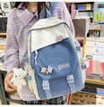 Blue and white color-block backpack worn by a model in a bookstore setting with a bear charm - Single Bag / Blue & Beige