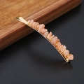 Detailed view of pink natural quartz stones hand-wired on a gold-plated metal hair clip - Sunstone Gold