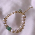 Baroque pearl bracelet with green jade beads and gold toggle clasp on beige silk fabric - Freshwater Pearl Emerald Style