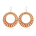 Detail view of round hollow wooden earrings with geometric sunburst patterns in brown - Style 8/Round Hollow Sunburst