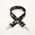 Close-up of leopard print bag strap with silver glitter and gold metal lobster clasps - Black