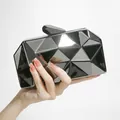 Fashionable black geometric clutch bag with mirror finish and metallic chain for evening events - Black