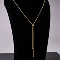 Adjustable bow necklace in rose gold stainless steel shown on a black velvet neck model - Adjustable Pull Y-Necklace / Gold