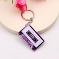 Detailed view of a purple cassette keychain with I LOVE FRIEND text on a beige base - Purple