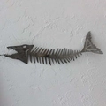 Artistic metal shark bone wall decor in dark grey finish on textured white wall - 25cm / Barracuda Pike Metal Fish