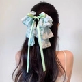 Green floral chiffon hair claw clip with long ribbons shown on dark hair - Fresh Green Floral