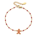 Detail of gingerbread man charm and red beads on a golden stainless steel bracelet - Red