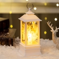 White Christmas lantern featuring angel silhouette and warm light on snowy background - White Angel