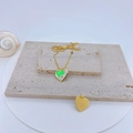 Detail of gold heart pendant with green and white yin yang pattern and O-chain - Green & White Tai Chi Heart