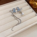 Detailed view of asymmetric butterfly earrings with blue crystals and rhinestone tassels - Blue Butterfly Long Tassel