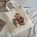 Off-white canvas tote bag featuring a cute festive bear and Christmas tree print - C10 Christmas Decorating Bear