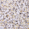 Macro shot of white acrylic alphabet beads with gold letters for DIY jewelry making - 4x7mm Gold Letters (100pcs)
