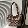 Ethnic style tote bag with colorful geometric patterns and decorative tassels - Red
