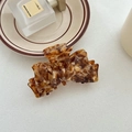 Elegant tortoiseshell acetate bow hair claw clip for women in warm amber pattern - Caramel color