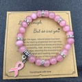 Pink cat eye stone bead bracelet with ribbon charm on inspirational gift card - Cat Eye Powder