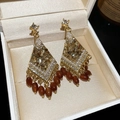 Macro detail of diamond-encrusted diamond-shaped crystal tassel earrings in brown finish - Gold Brown Ethnic Pearl Tassel (49#)