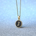 Golden necklace with black circular disk pendant featuring capital letter J design - Letter J