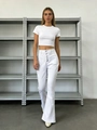 Close-up of white high-waisted flared jeans featuring multi-button fly and slim fit design - XS / White