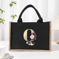 Black canvas tote bag with gold letter Q and floral print and durable black handles - Bronze Floral Letter Q