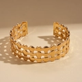 Detailed view of triple-layered hollow oval metal cuff bracelet with geometric shadows - Gold