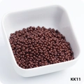 Macro view of 3mm brown wear-resistant glass seed beads in a white ceramic bowl - KK11 Coffee