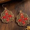Detailed view of bohemian gold earrings with red thread weaving on rustic wood - 08 Antique Gold 3010
