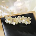 Floral hair clip with cat eye stones and pearls on a gold alloy spring base - Gold Pearl Opal Freesia Spring Clip