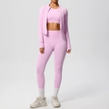 Detailed view of pink three-piece yoga set with zip-up jacket, sports bra, and leggings - Sakura Pink