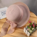 Pink wide brim straw sun hat with matching ribbon bow on a rustic wooden table - One Size(Adjustable) / Folded Brim Pink