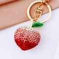 Close-up of sparkling pink and white gradient rhinestone pineapple keychain with golden metal ring - Gradient Peach