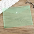 Light green semi-transparent A4 plastic folder with white snap button on a wooden desk - 18 Microns Green Plain