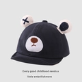 Close-up of baby baseball cap featuring 3D bear ears with cross and polka dot patterns - 45-48cm / Navy Blue