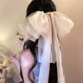 Large cream organza bow hair clip with elegant long ribbons on model back view - Off White