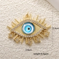 Detailed view of evil eye pendant with blue resin and white zircons, 3.8cm width - A0250