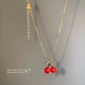 Elegant gold titanium steel necklace with red cherry pendant and sparkling leaf detail - X950 Gold - Cherry Pendant