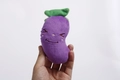Plush purple eggplant dog toy with green leaves and embroidered smiling face - Purple Eggplant