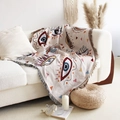Bohemian cotton woven blanket with abstract eye patterns and fringe on white sofa - XT07-12 Abstract Eye Geometric