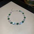 Macro shot of silver heart bracelet with alternating green and clear crystals - 42# Silver Green White Heart Zircon Style