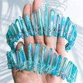 Macro shot of blue aura quartz crystal crown with silver wire wrap being held by hands - Green + Silver Wire Silver Headband 2