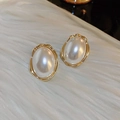 Close-up of vintage gold floral earrings with pearls on white plush background - 58# Gold Oval Pearl