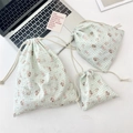 Close-up of three plaid drawstring storage bags with cartoon rabbit and bear prints - Salt Style Bunny