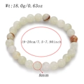 Detailed macro view showing 8mm natural stone beads and precise dimensions of the bracelet - 8mm Beads / Huaqing Jade (AB855-04)