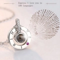 Macro detail of silver projection necklace showing Roman numerals and zircon stones - White Gold Circular Roman Numeral Projection Style