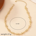 Détail d'un collier doré style épines montrant la longueur 33+7CM et le poids 21g - Doré