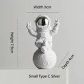 Silver and white astronaut figurine on moon in V-sign pose, size 7.9cm small model C - Small Plated Silver Model C