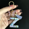 Detail of purple resin letter Z keychain with heart sequins, butterfly, and tassel - Letter Z / Butterfly Tassel 8-Shape Buckle