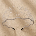 Detail of silver bridal headband with crystal beads and rhinestones on beige background - Silver