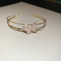 Detail of gold double-layer butterfly cuff with pink zircon pave setting and crystals - Gold