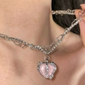 Macro detail of silver layered cross necklace featuring a pink heart stone and crystals - Pink Heart Tennis Chain Necklace Style (5669001)